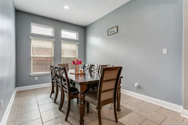 a dining room with furniture and window