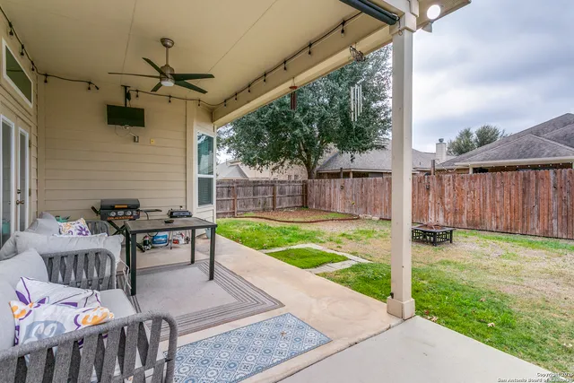 a view of a patio with table and chairs potted plants with wooden floor