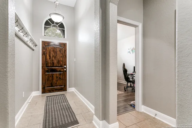 a view of a hallway view with wooden floor and staircase