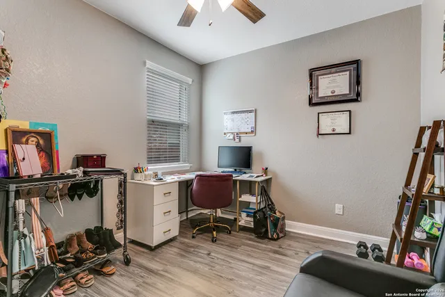 a view of a workspace with furniture and a window