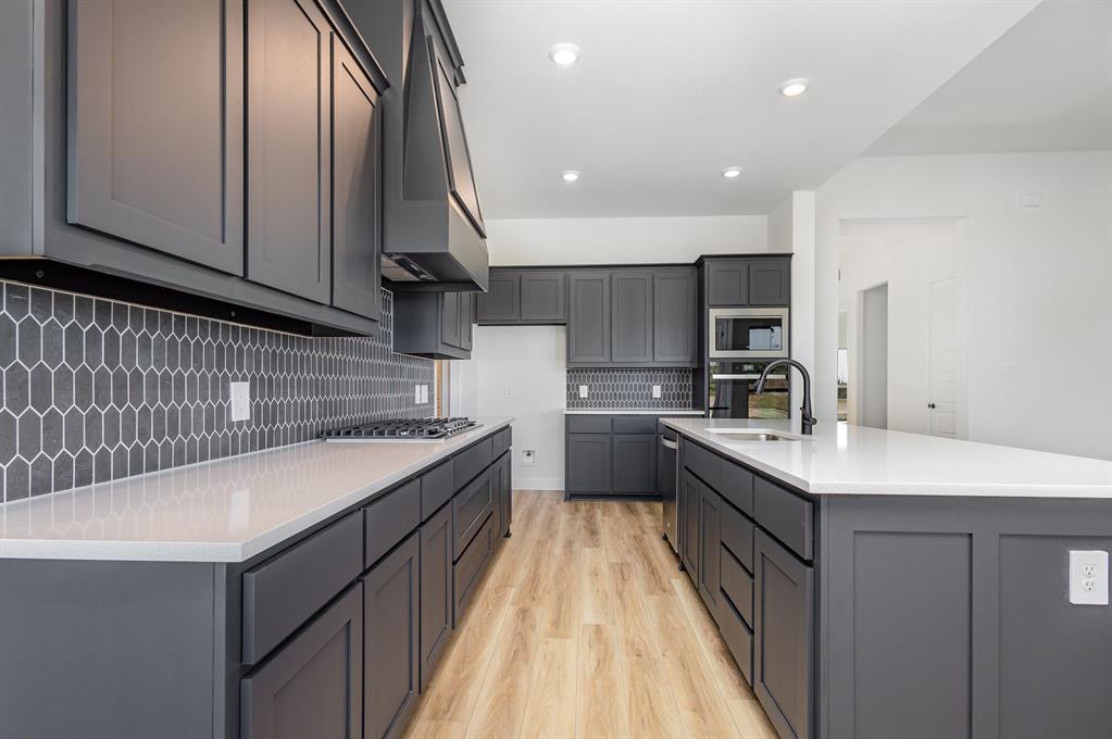 6841 Hayes Road Midlothian, TX 76065 - Photo 11 of 27 a kitchen with a sink stove and cabinets