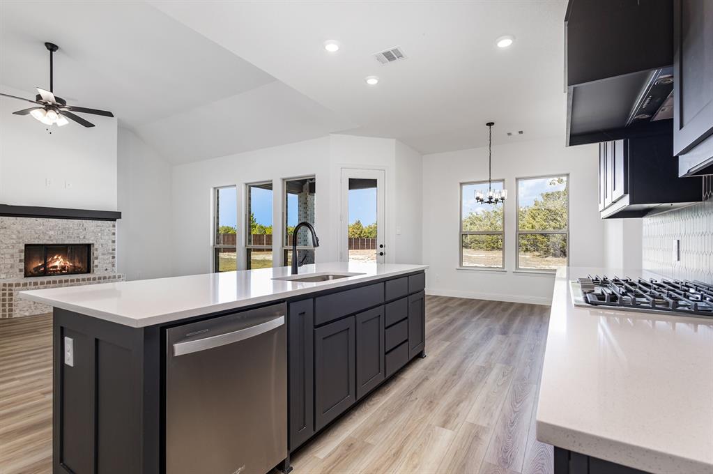 6841 Hayes Road Midlothian, TX 76065 - Photo 14 of 27 a kitchen with sink cabinets and wooden floor