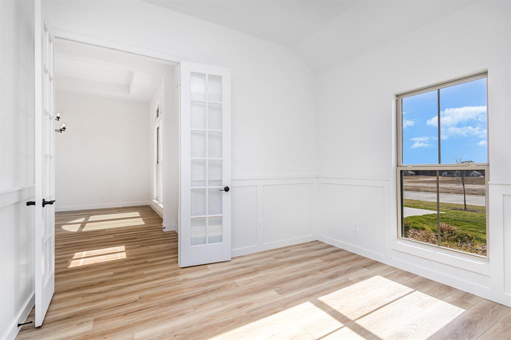 6841 Hayes Road Midlothian, TX 76065 - Photo 16 of 27 a view of empty room with window and wooden floor