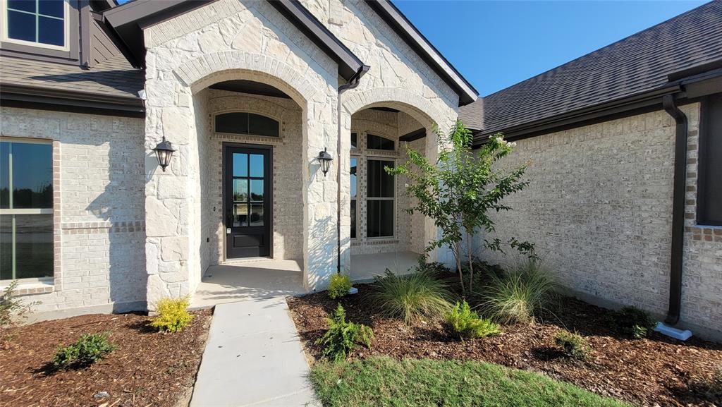 6841 Hayes Road Midlothian, TX 76065 - Photo 2 of 27 a front view of a house with garden