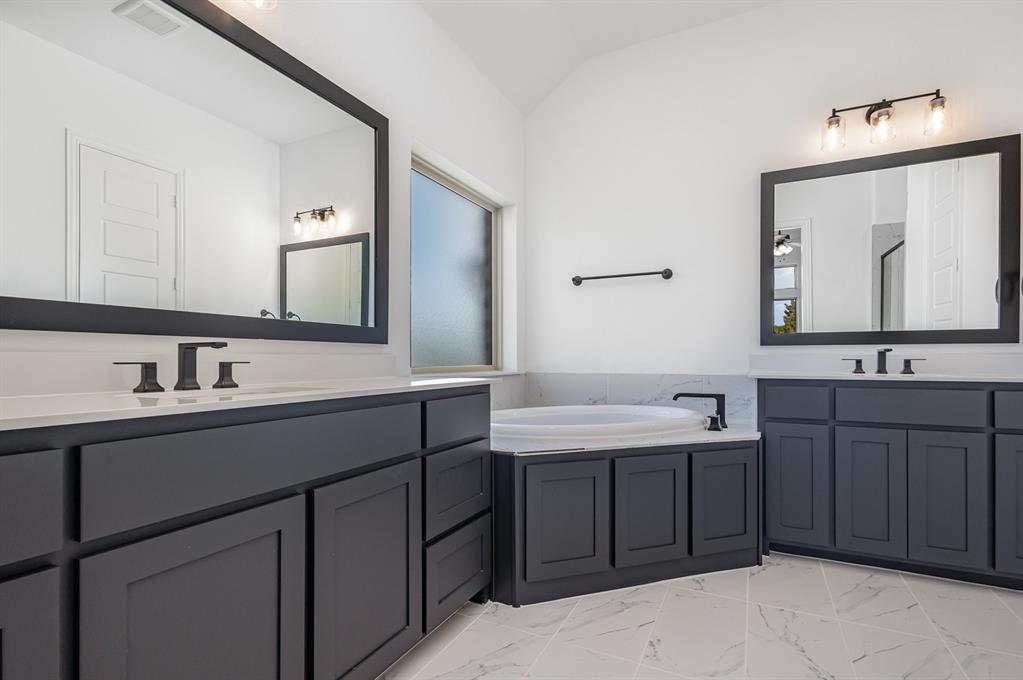 6841 Hayes Road Midlothian, TX 76065 - Photo 26 of 27 a bathroom with a double vanity sink and mirror