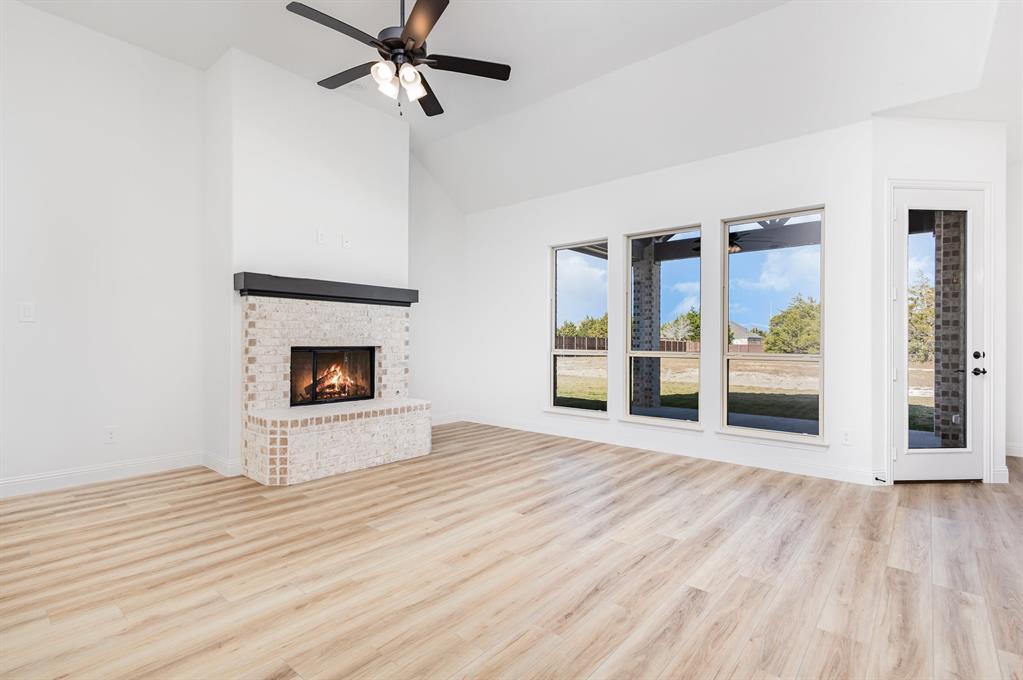 6841 Hayes Road Midlothian, TX 76065 - Photo 5 of 27 a view of empty room with wooden floor and fireplace
