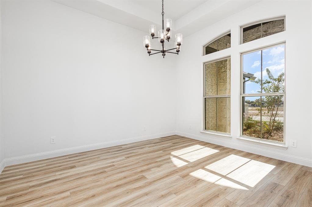 6841 Hayes Road Midlothian, TX 76065 - Photo 9 of 27 a view of a room with wooden floor and chandelier