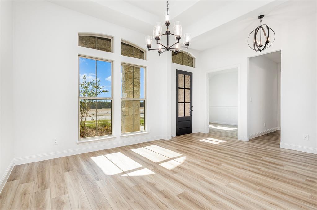 6841 Hayes Road Midlothian, TX 76065 - Photo 10 of 27 a view of an empty room with a window and wooden floor
