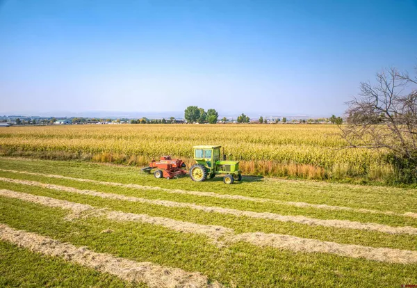 a living room with furniture a flat screen tv and a large window