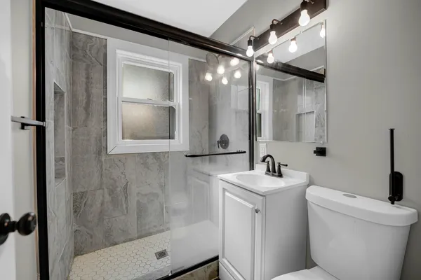 a bathroom with a sink toilet and shower