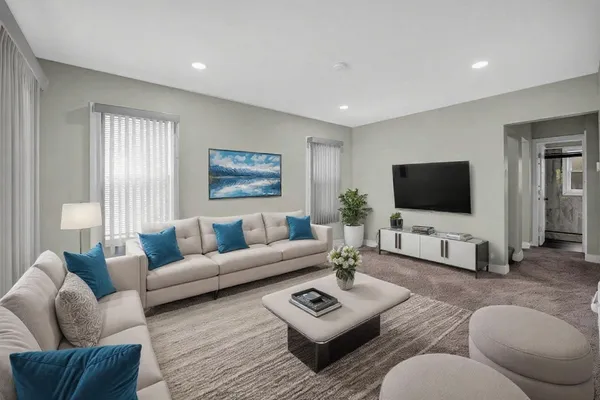 a living room with furniture and a flat screen tv