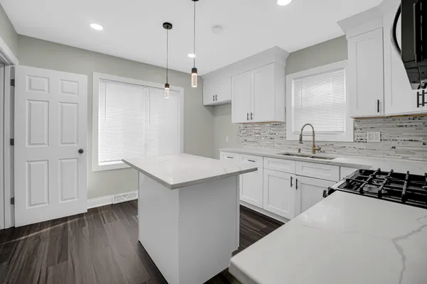 a kitchen with a sink stove and cabinets