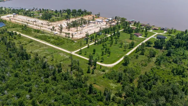 an aerial view of a residential houses with outdoor space and street view