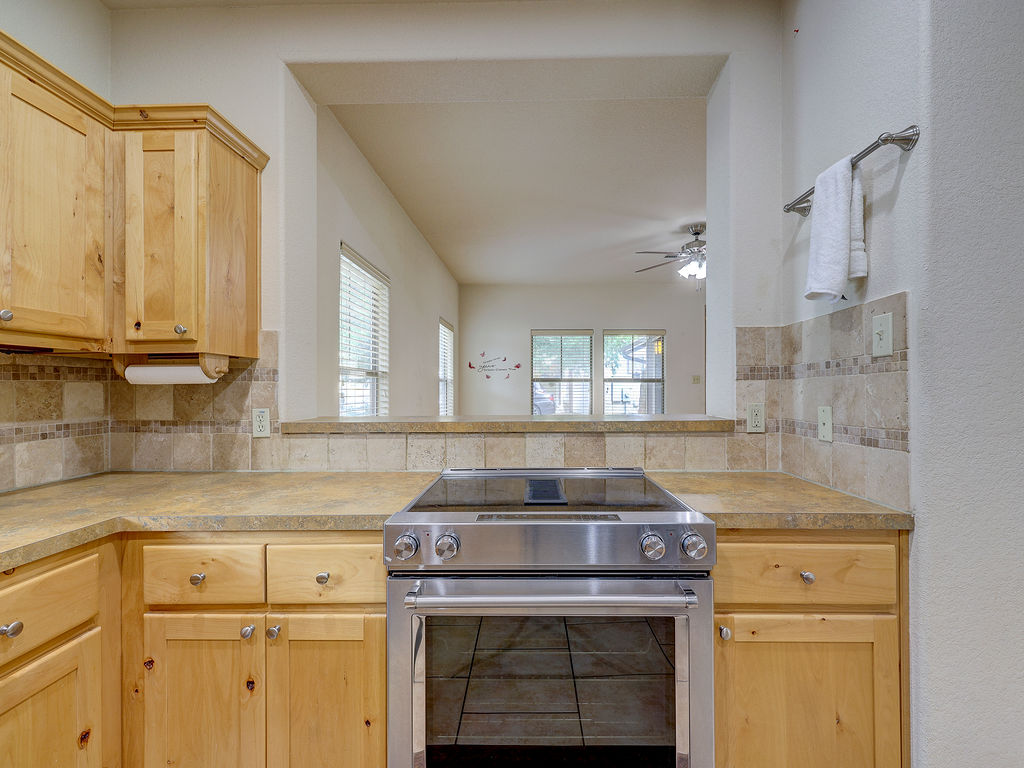 9707 Anderson Mill Road, Unit 22 Austin, TX 78750 - Photo 14 of 39 A well-appointed kitchen features a pass-through window to the living area.