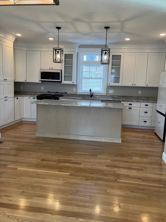 23 Jackson Road Webster, MA 01570 - Photo 5 of 42 a large kitchen with stainless steel appliances granite countertop a stove a sink dishwasher and a microwave oven on the wooden floor