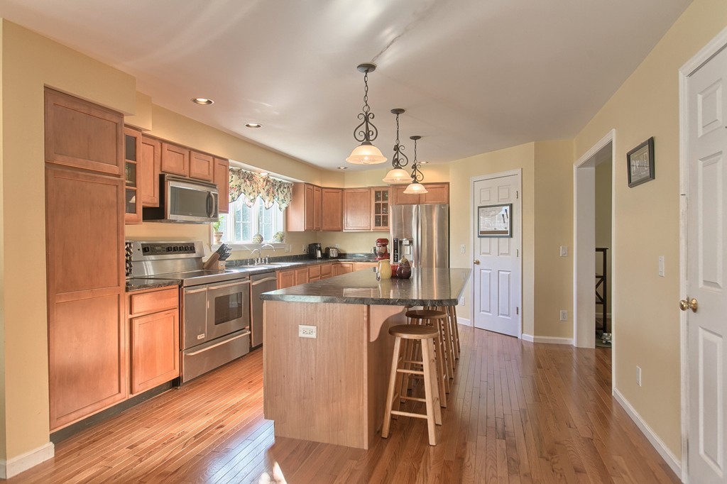 112 Beaman Road Princeton, MA 01541 - Photo 5 of 30 a kitchen with stainless steel appliances granite countertop a refrigerator a stove a sink dishwasher and a dining table with wooden floor