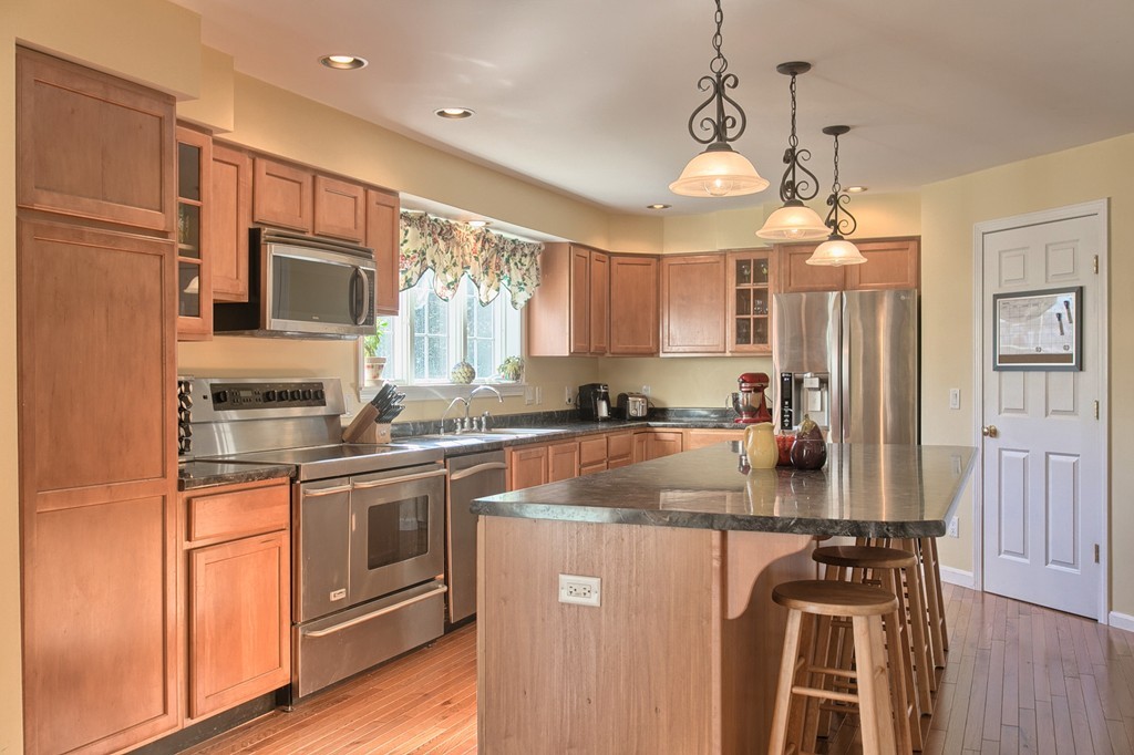 112 Beaman Road Princeton, MA 01541 - Photo 6 of 30 a kitchen with stainless steel appliances granite countertop a sink a stove a refrigerator cabinets and wooden floor