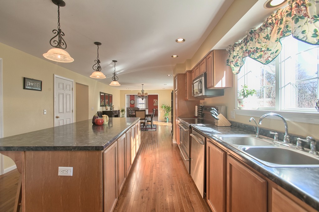 112 Beaman Road Princeton, MA 01541 - Photo 8 of 30 a kitchen with granite countertop a sink dishwasher a stove and a dining table with wooden floor