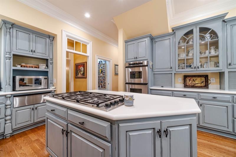 200 Johnson Road Suwanee, GA 30024 - Photo 11 of 71 a kitchen with stainless steel appliances granite countertop a stove and a refrigerator