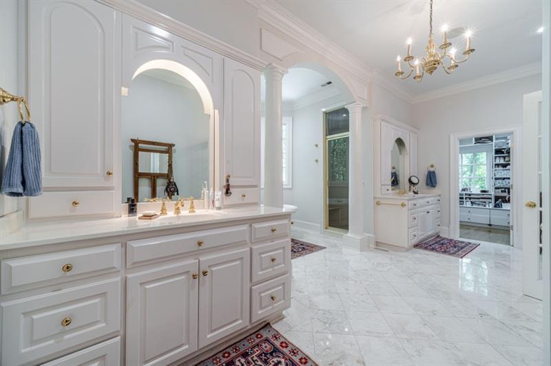 200 Johnson Road Suwanee, GA 30024 - Photo 21 of 71 a spacious en suite bathroom with a double vanity sink and a mirror