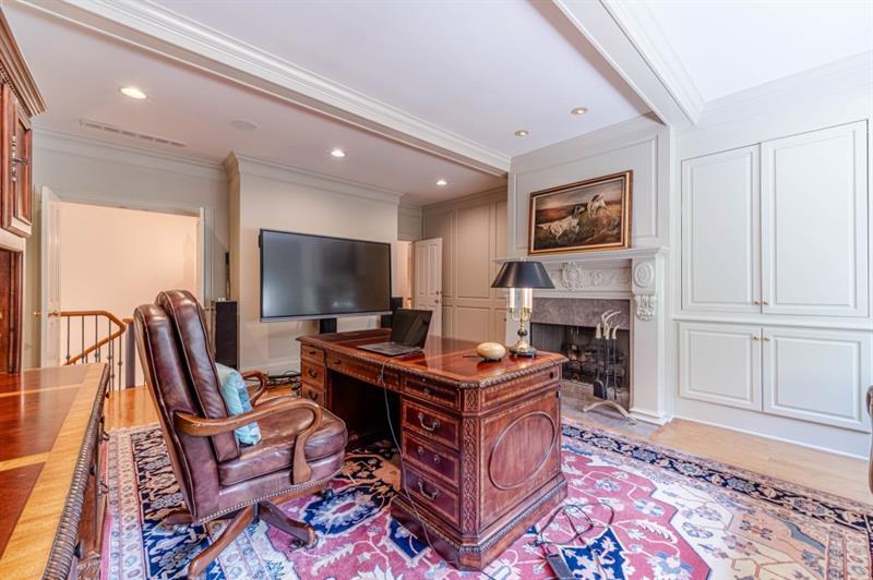 200 Johnson Road Suwanee, GA 30024 - Photo 26 of 71 a living room with furniture a flat screen tv and a fireplace