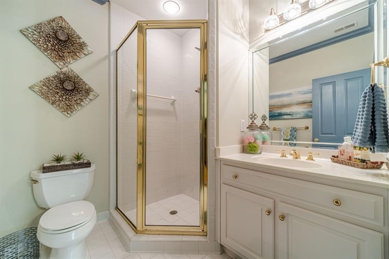 200 Johnson Road Suwanee, GA 30024 - Photo 29 of 71 a bathroom with a toilet sink and shower