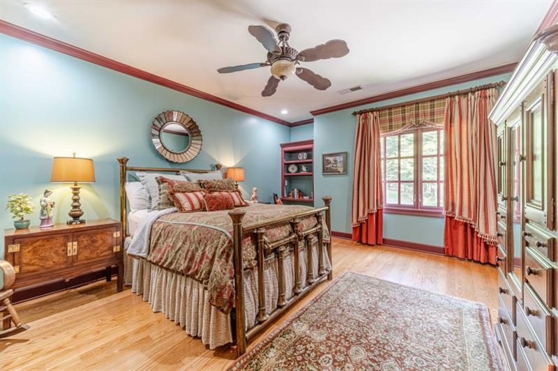 200 Johnson Road Suwanee, GA 30024 - Photo 30 of 71 a bedroom with a bed and a chandelier