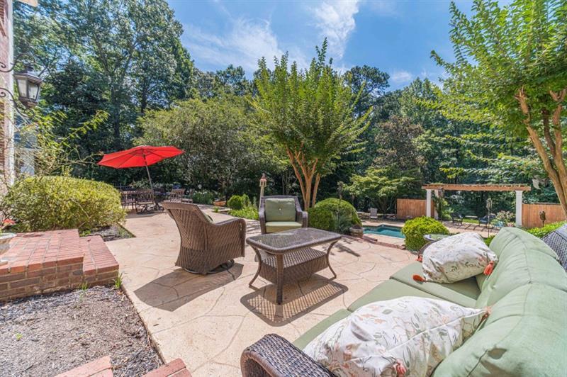 200 Johnson Road Suwanee, GA 30024 - Photo 66 of 71 a view of a patio with furniture and a yard