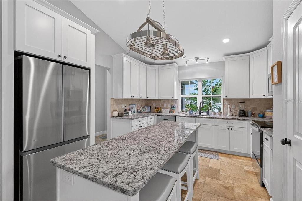 8160 Southeast 164th Place Summerfield, FL 34491 - Photo 13 of 56 a kitchen with stainless steel appliances granite countertop a refrigerator sink and cabinets