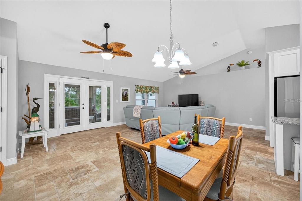 8160 Southeast 164th Place Summerfield, FL 34491 - Photo 21 of 56 a dining room with furniture a chandelier and window