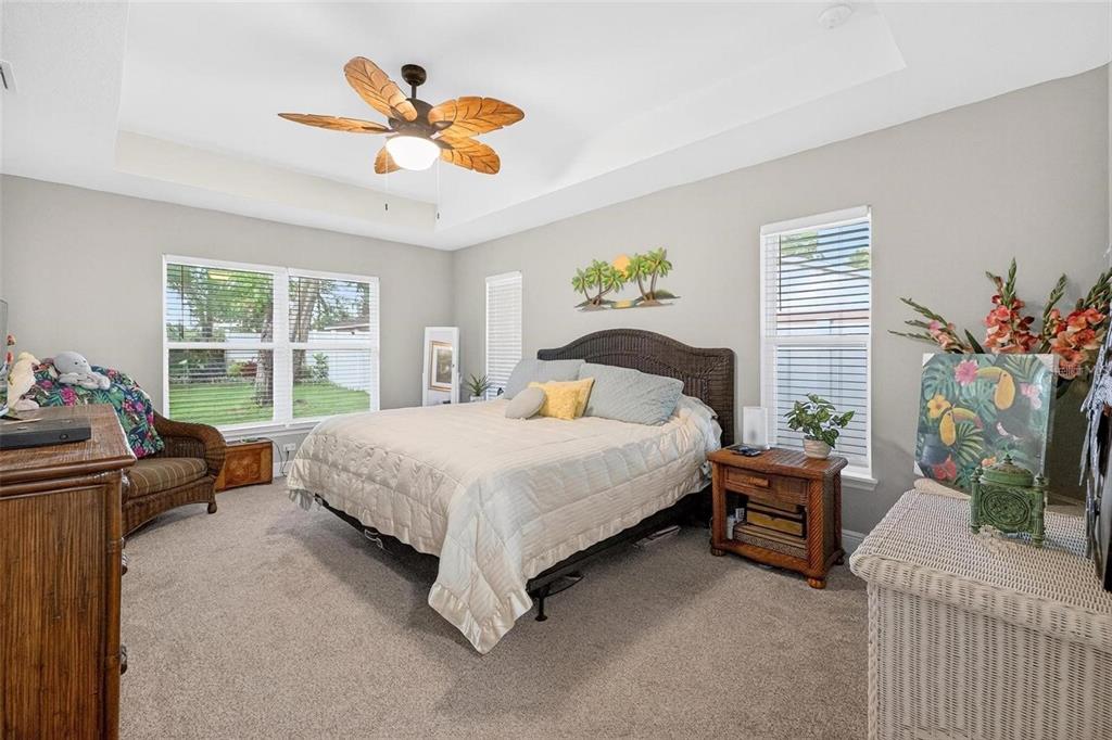 8160 Southeast 164th Place Summerfield, FL 34491 - Photo 23 of 56 a bedroom with a bed and a chandelier