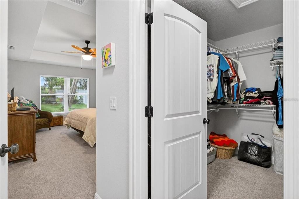 8160 Southeast 164th Place Summerfield, FL 34491 - Photo 24 of 56 a view of walk in closet with clothes and shoes