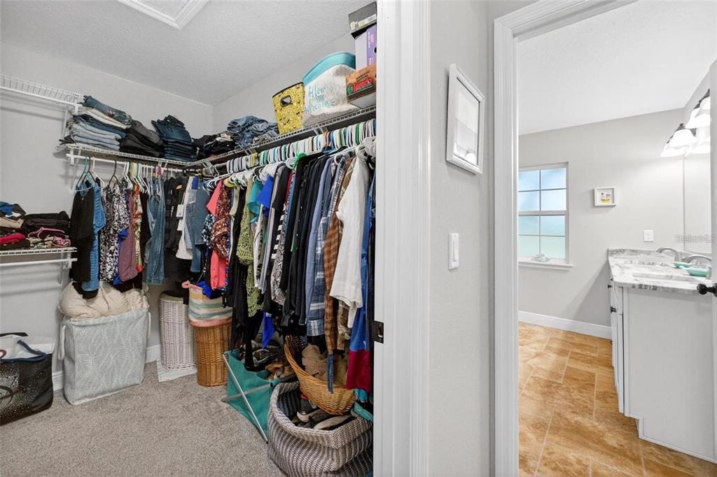 8160 Southeast 164th Place Summerfield, FL 34491 - Photo 25 of 56 a view of walk in closet with clothes and shoes