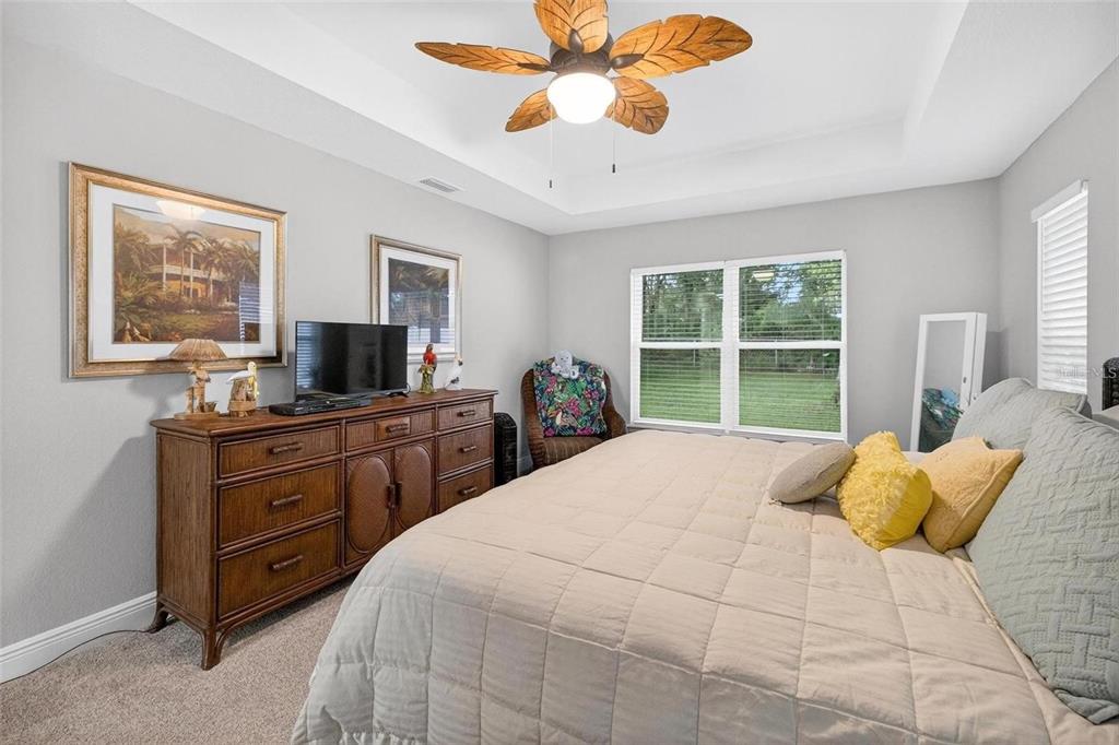 8160 Southeast 164th Place Summerfield, FL 34491 - Photo 28 of 56 a bedroom with a large bed and a flat tv screen on dresser