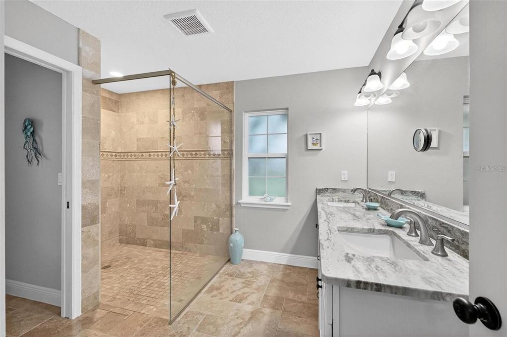 8160 Southeast 164th Place Summerfield, FL 34491 - Photo 29 of 56 a bathroom with a granite countertop sink a mirror and shower