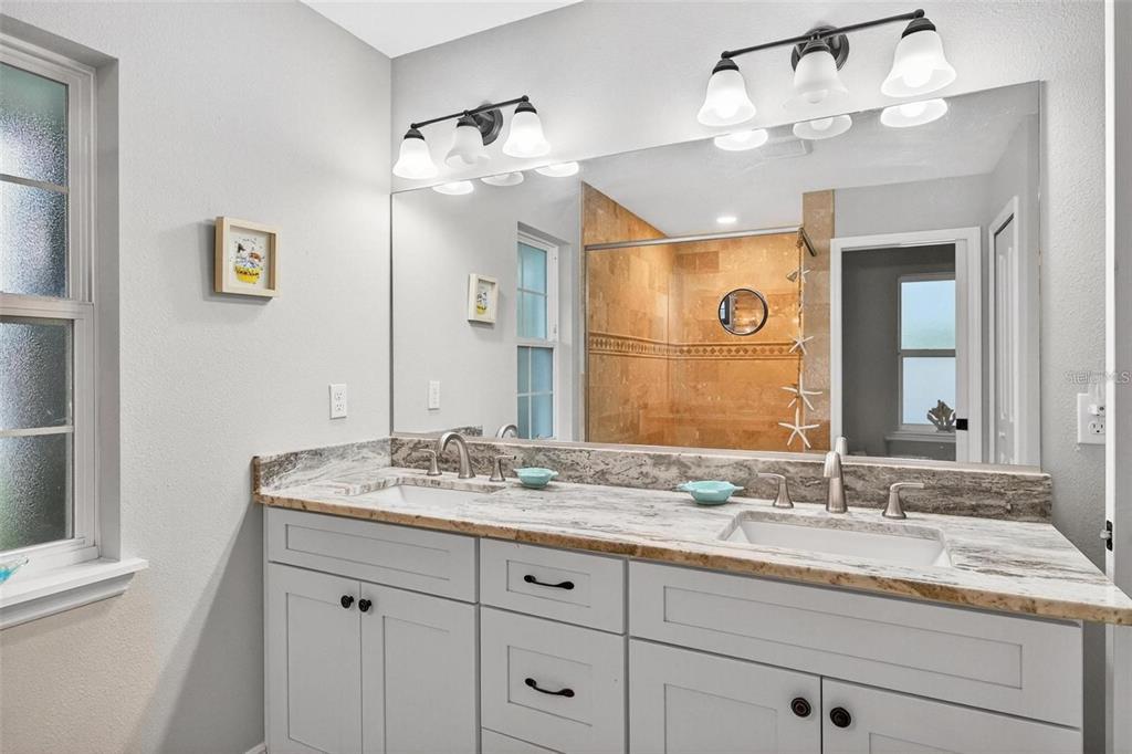 8160 Southeast 164th Place Summerfield, FL 34491 - Photo 31 of 56 a bathroom with a granite countertop double vanity sink and a mirror