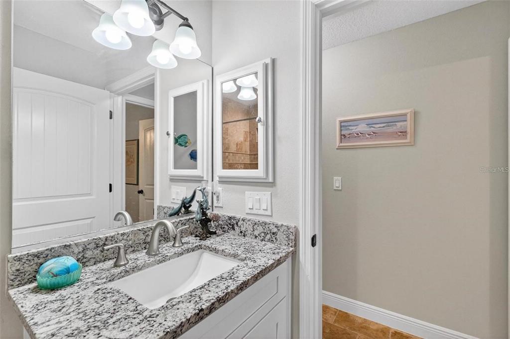 8160 Southeast 164th Place Summerfield, FL 34491 - Photo 40 of 56 a bathroom with a granite countertop sink a large mirror and a shower