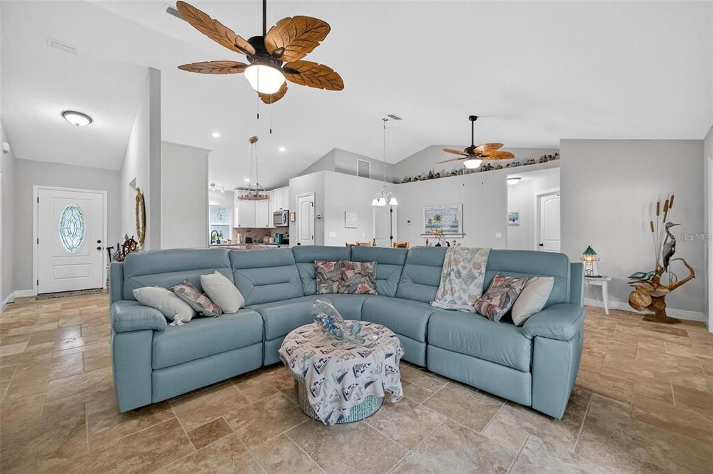 8160 Southeast 164th Place Summerfield, FL 34491 - Photo 5 of 56 a living room with furniture kitchen view and a chandelier