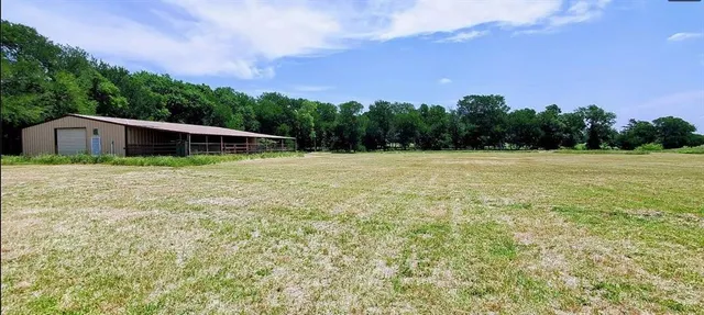 a backyard of a house with lots of green space