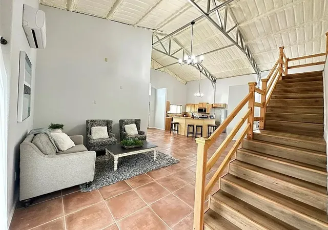 a living room with furniture and stairs