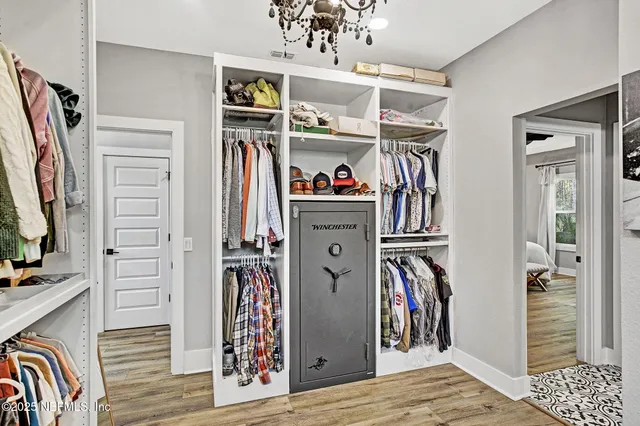 a view of walk in closet with clothes and shoes