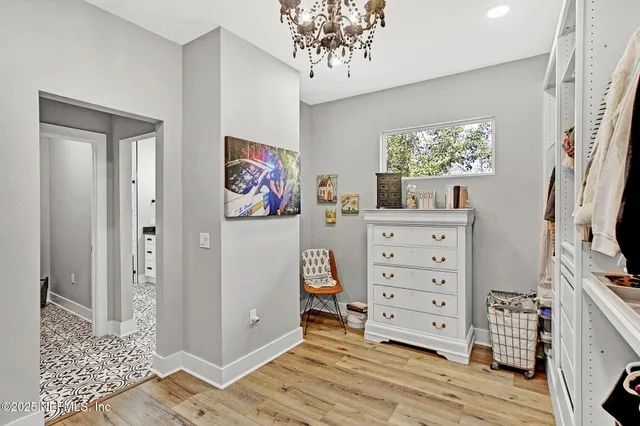 a view of a bedroom with workspace and natural light