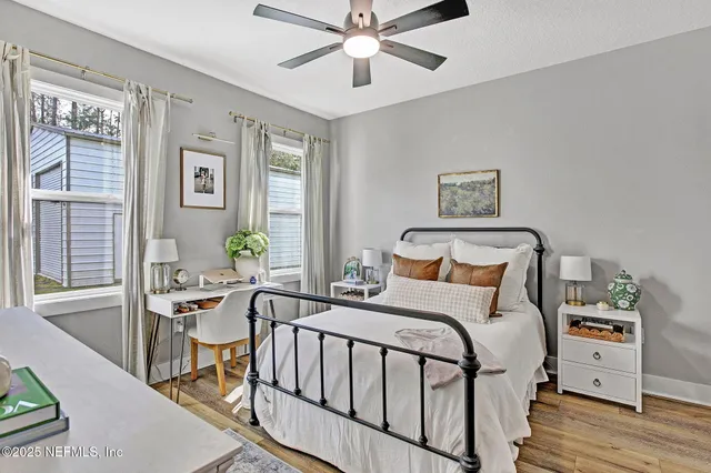 a bedroom with a bed and a chandelier