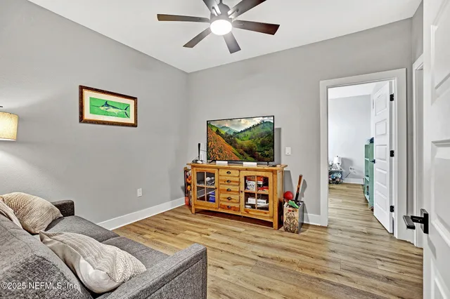a living room with furniture and a wooden floor