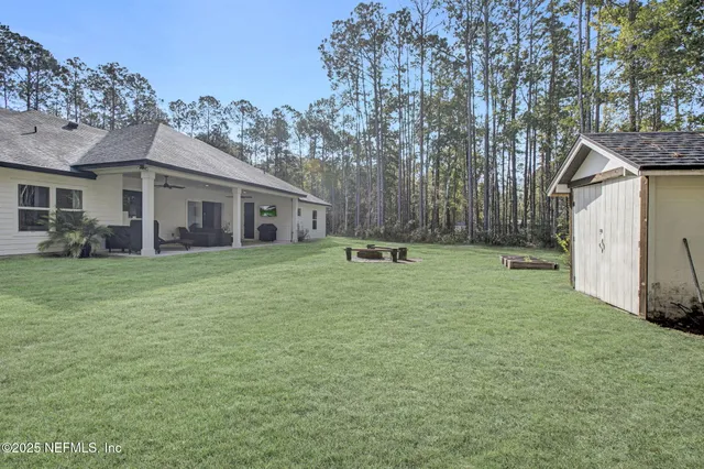 a view of a house with a yard and sitting area