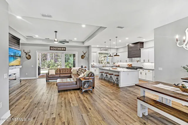a living room with kitchen island furniture and a wooden floor
