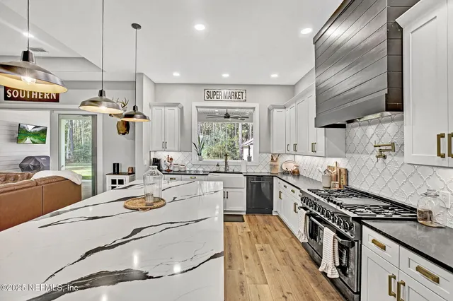 a kitchen with stove a sink and refrigerator