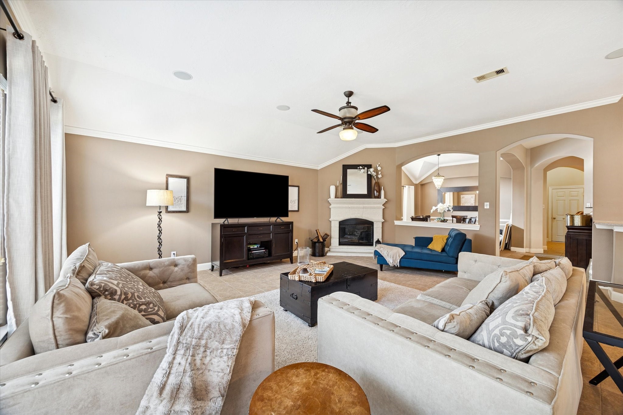 6315 Oakmont Creek Drive Spring, TX 77379 - Photo 3 of 16 a living room with furniture flat screen tv and a fireplace