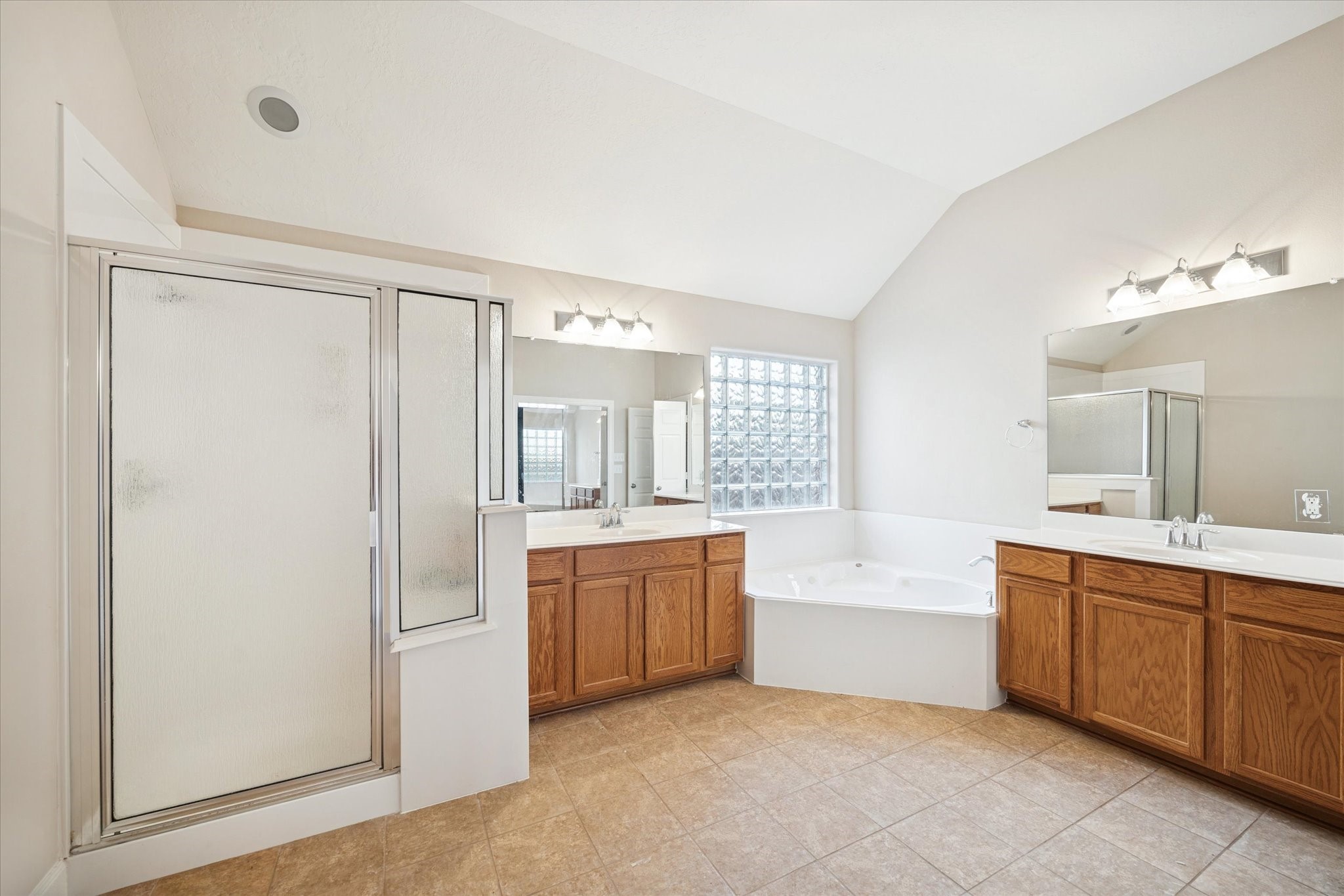 6315 Oakmont Creek Drive Spring, TX 77379 - Photo 9 of 16 a large bathroom with a tub sink shower and mirror