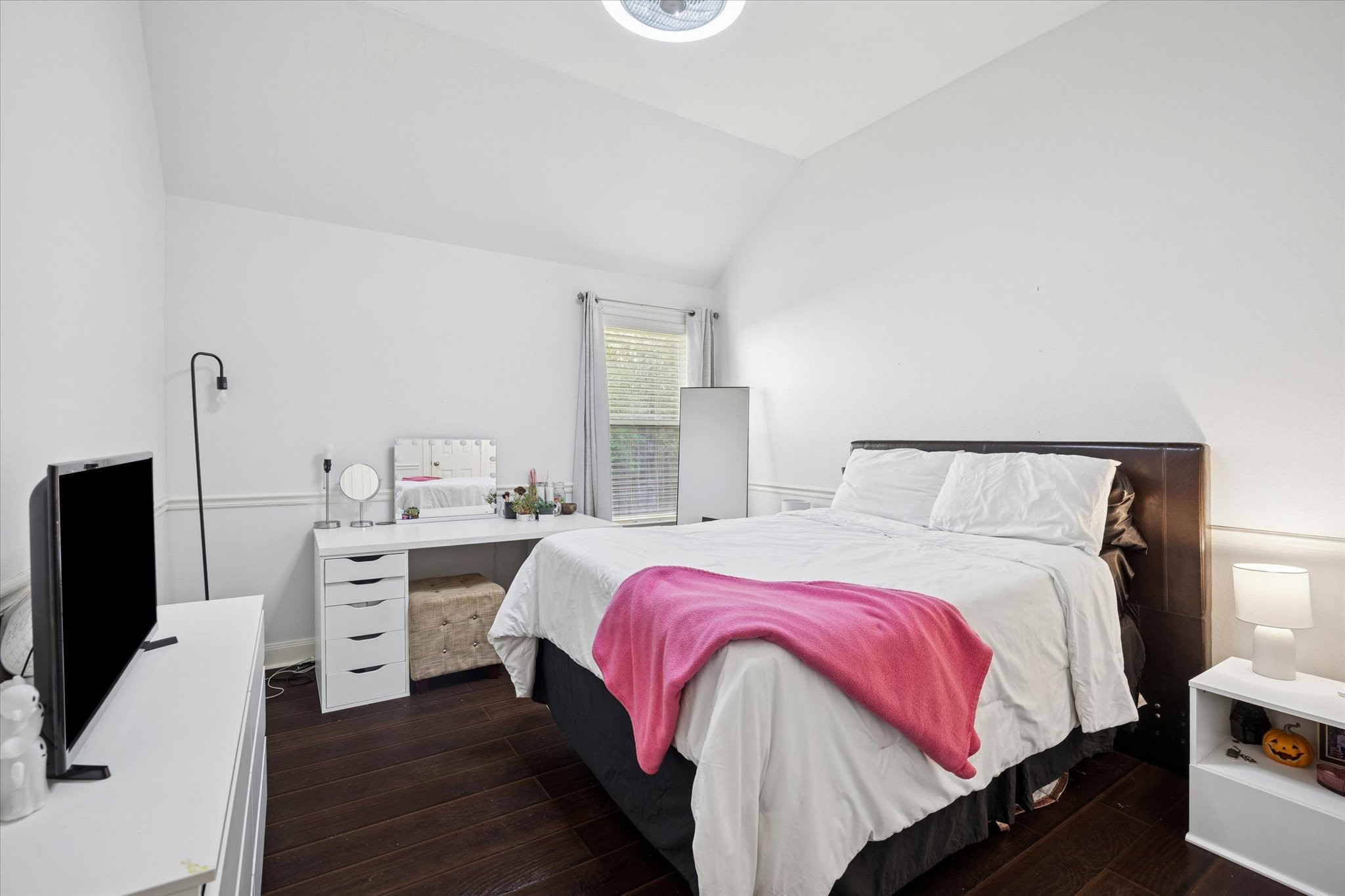 6315 Oakmont Creek Drive Spring, TX 77379 - Photo 10 of 16 a bedroom with a bed and a flat screen tv